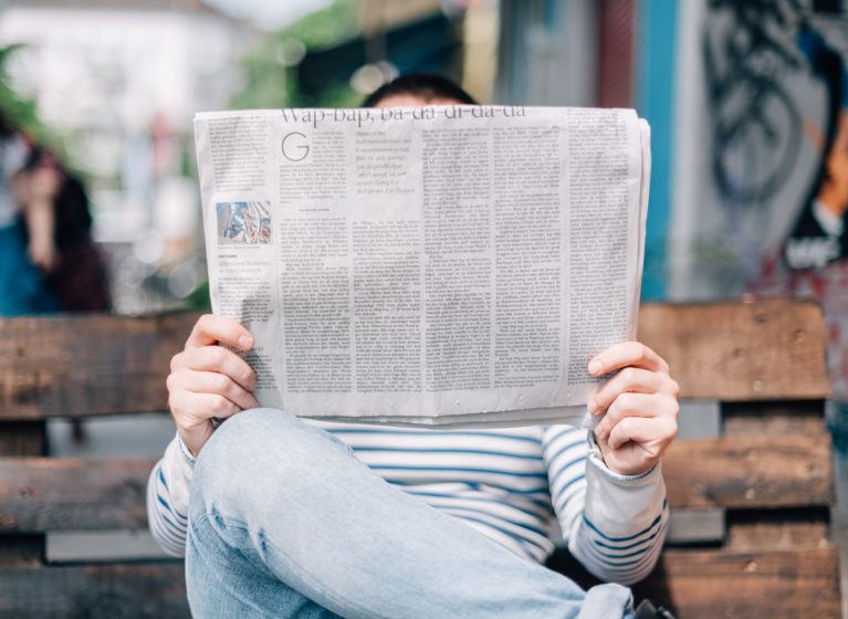 Person reading a newspaper