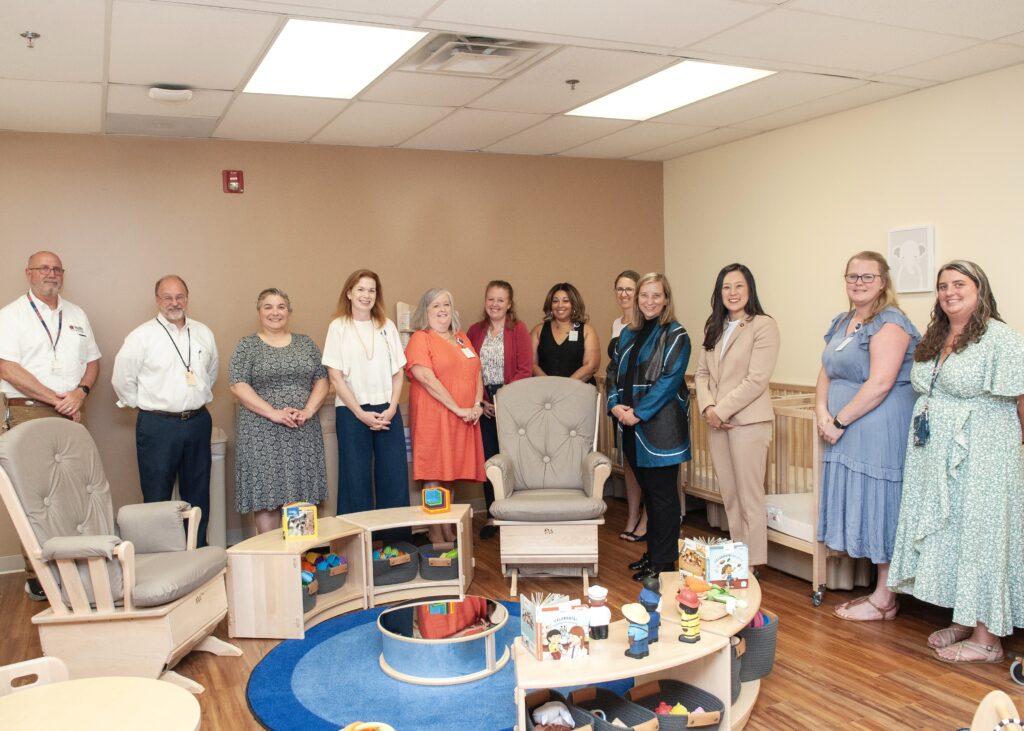Malcolm Cole Childcare Center (MCCCC) team and UVA Health Facilities Management and Leadership group photo in new MCCCC infant room